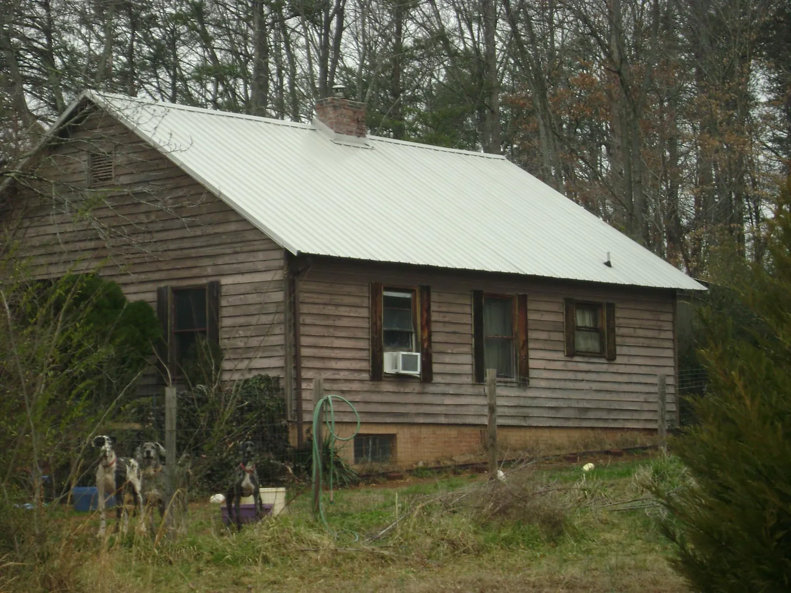 White metal roof on an old wood sided farmhouse, from a Metal Roof Installation job in Ephrata